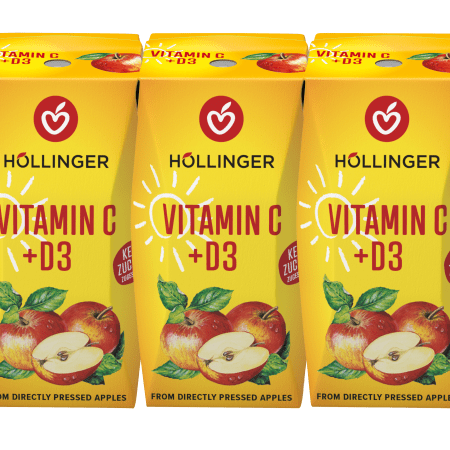 Eine gelbe Höllinger Apfelsaft-Packung mit Vitamin C + D3 auf der Äpfel und eine Sonne abgebildet sind.
